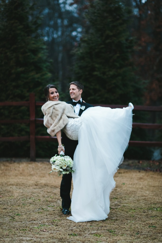 a small patch of dead grass next to a gravel parking lot but still beautiful